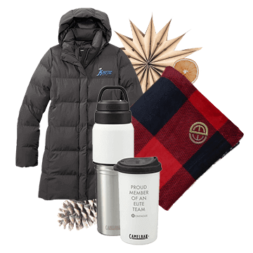 Winter jacket, mugs, and plaid blankets with custom logos displayed with holiday decorations.